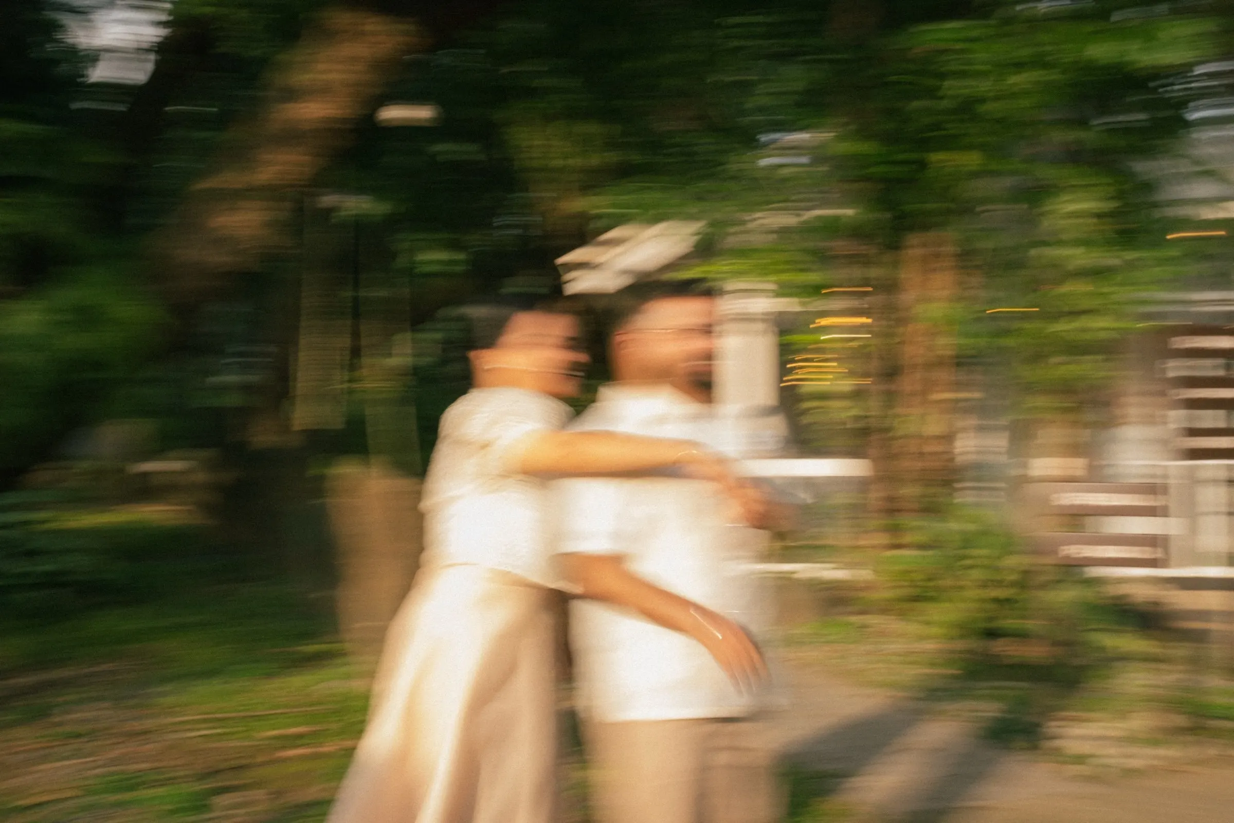 Colleen and Kunal dancing in the garden, blurred by a slow shutter